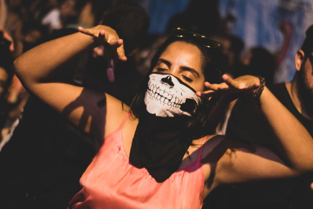 Party Girl with Skull Mask on Techno Party